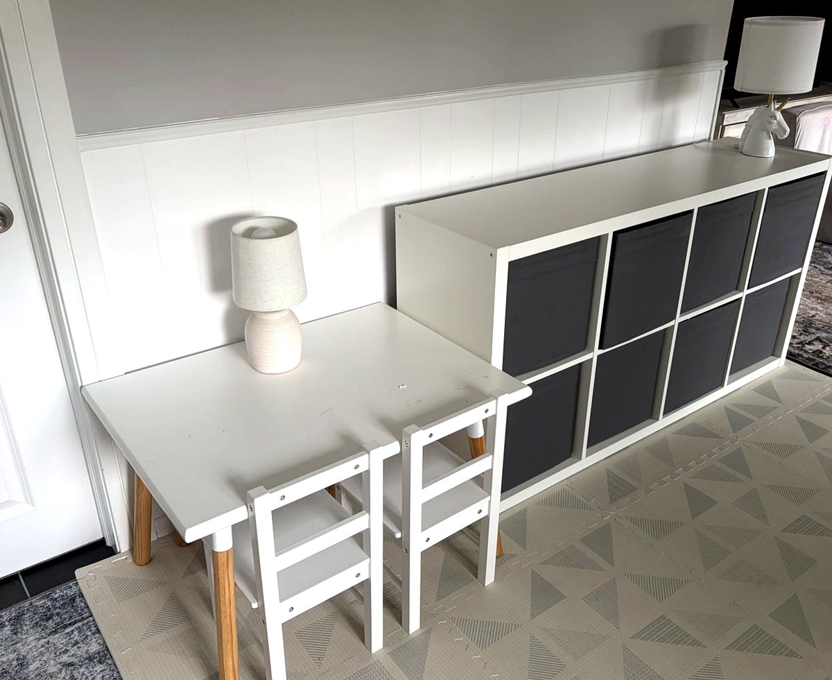 Kids craft table and cube storage bins in a bright playroom